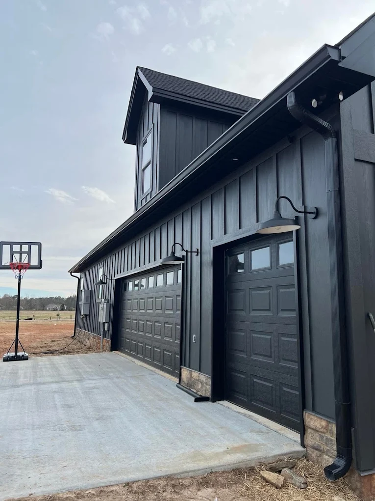 Dark gutters and downspouts above garage doors