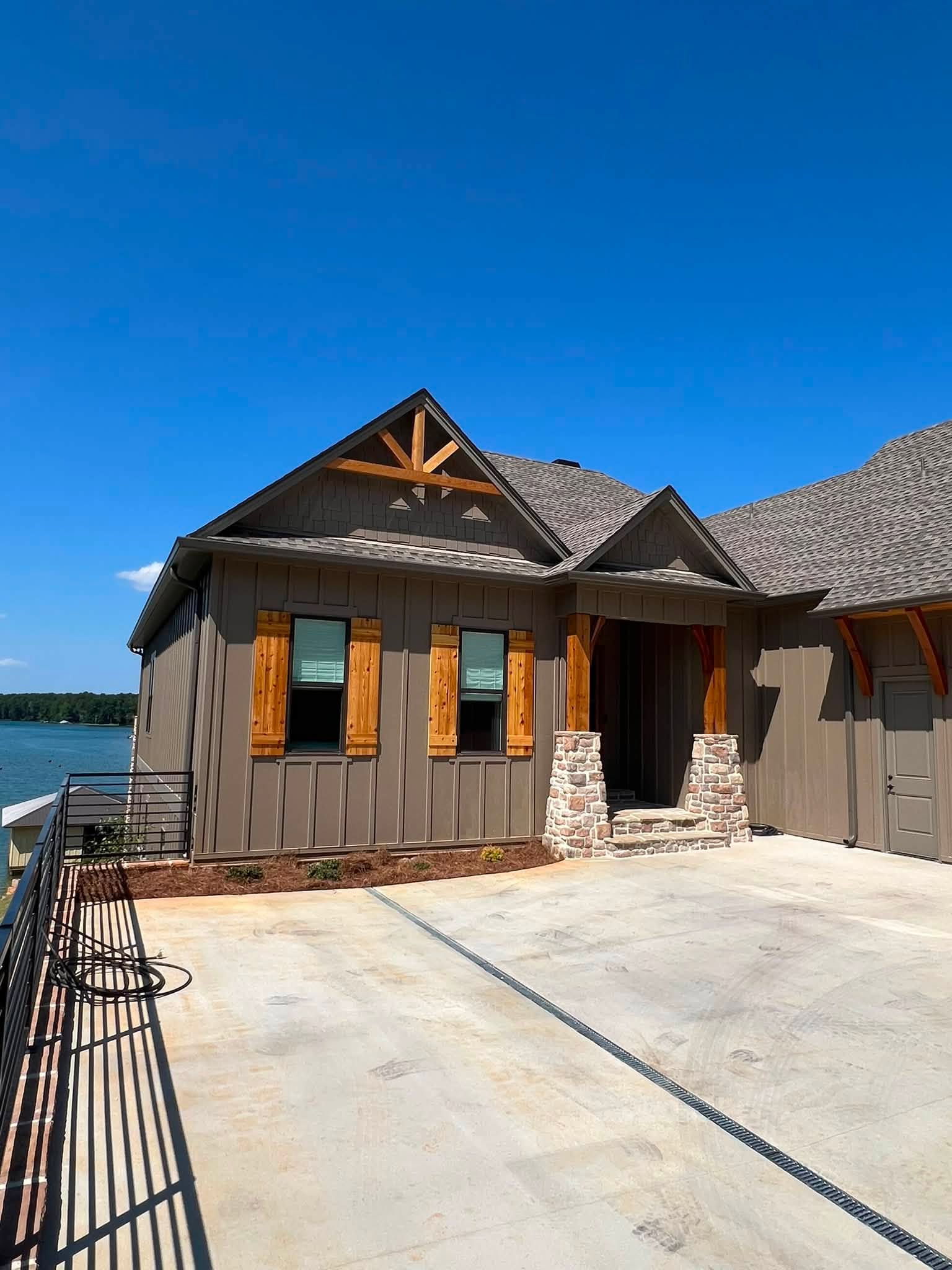 Gutter and downspout beside a lakeside home entrance