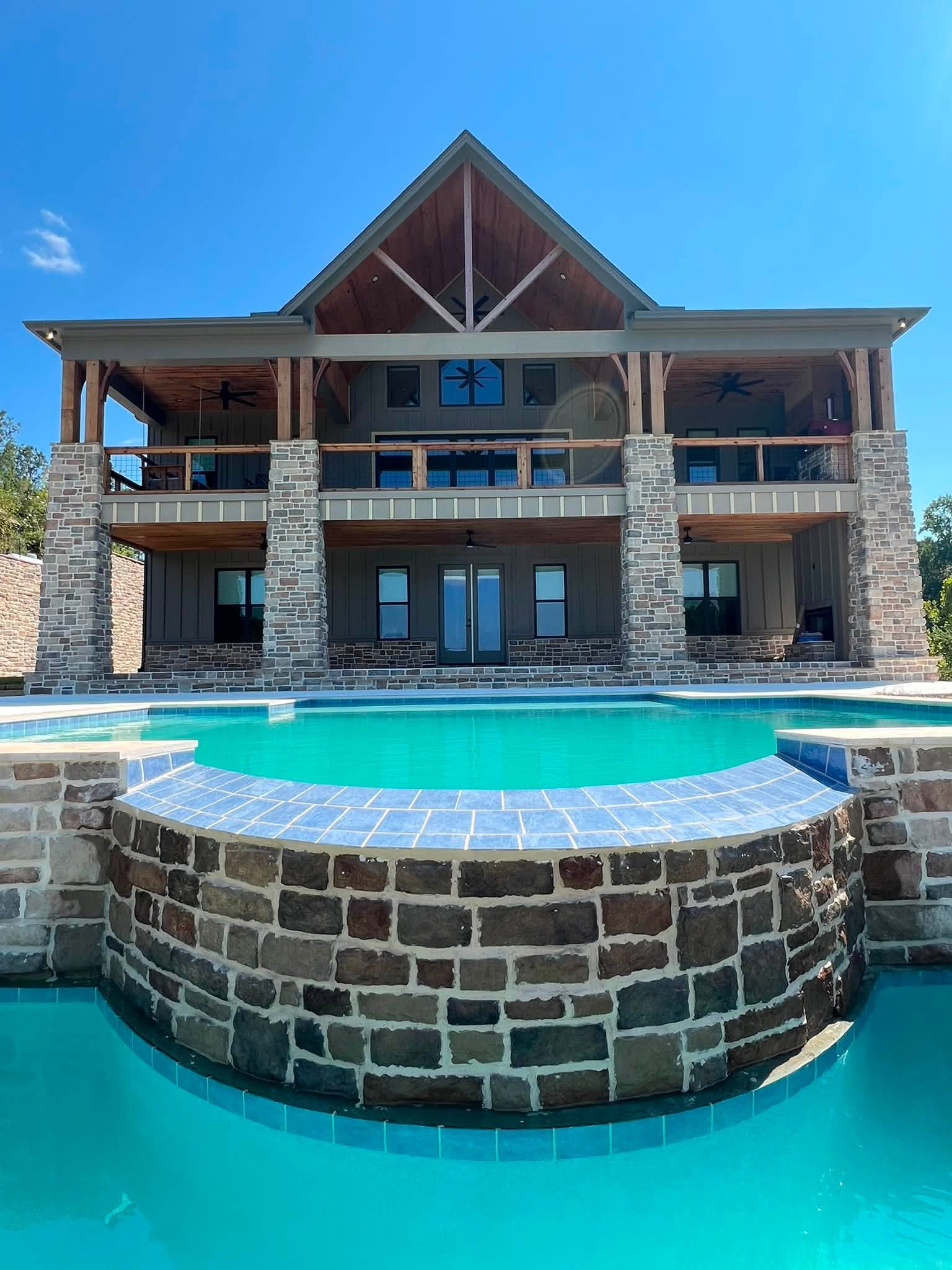 Rear roofline above a lakeside home's pool