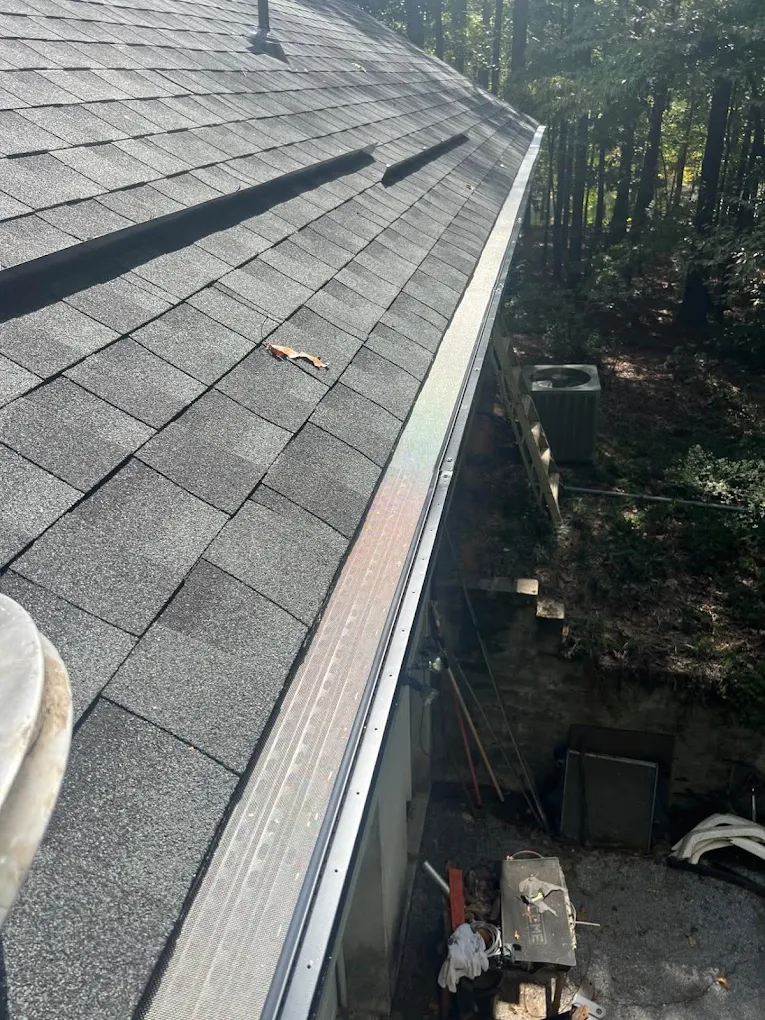 Mesh gutter guard along a long shingle roof edge
