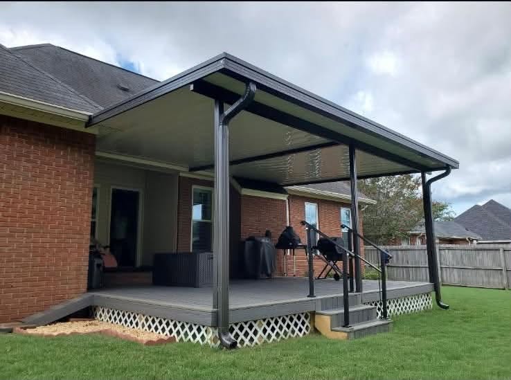 Dark gutters and downspouts framing a raised covered deck