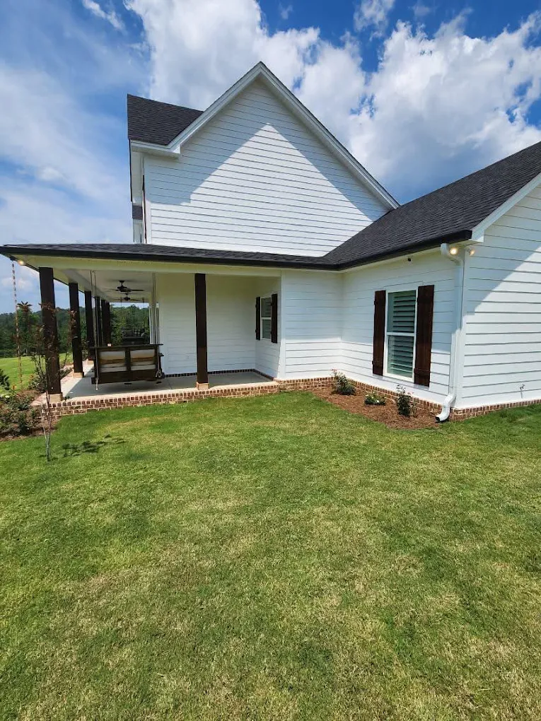 White gutters and downspout around a farmhouse porch